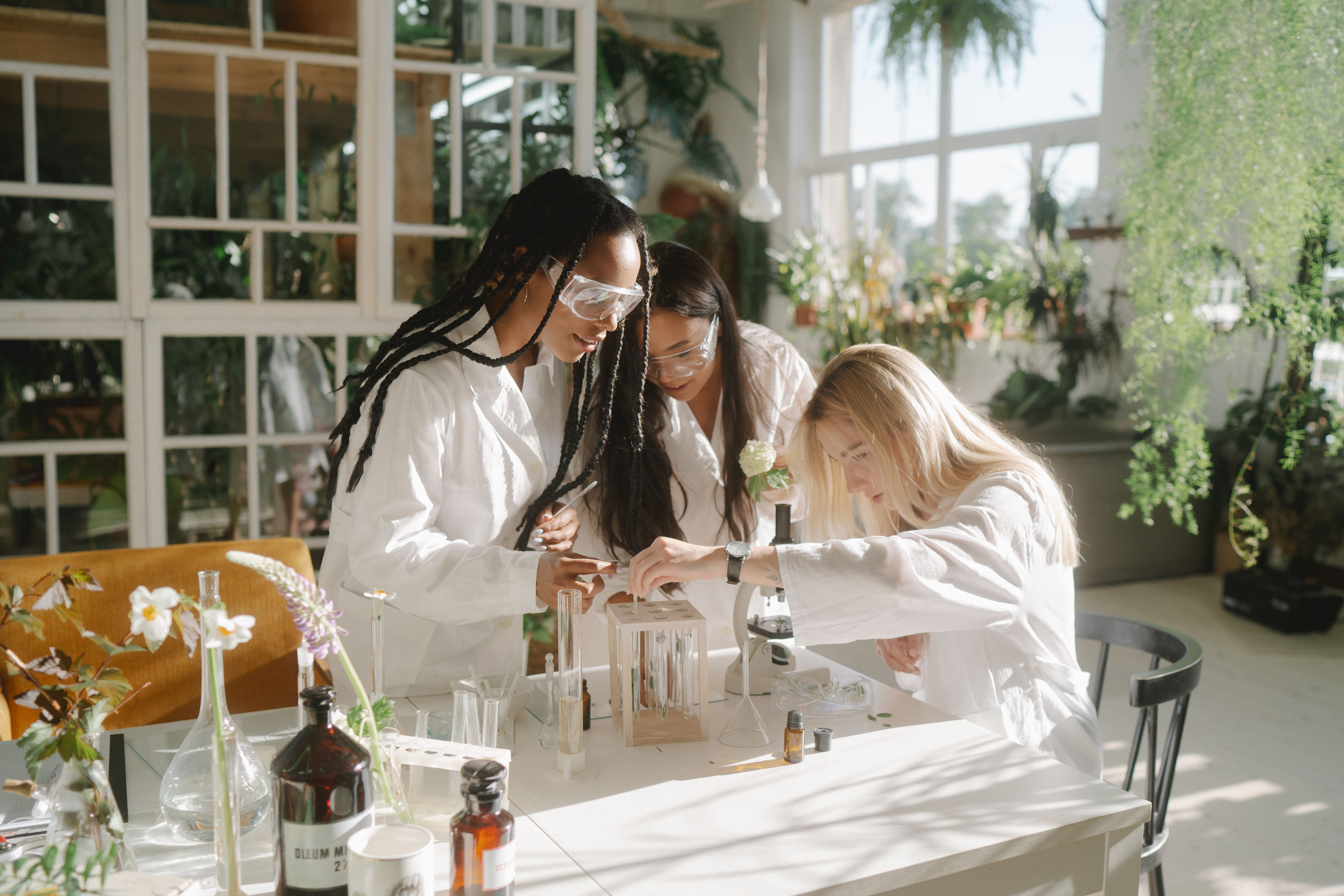 Three researchers collaborating in a bright laboratory