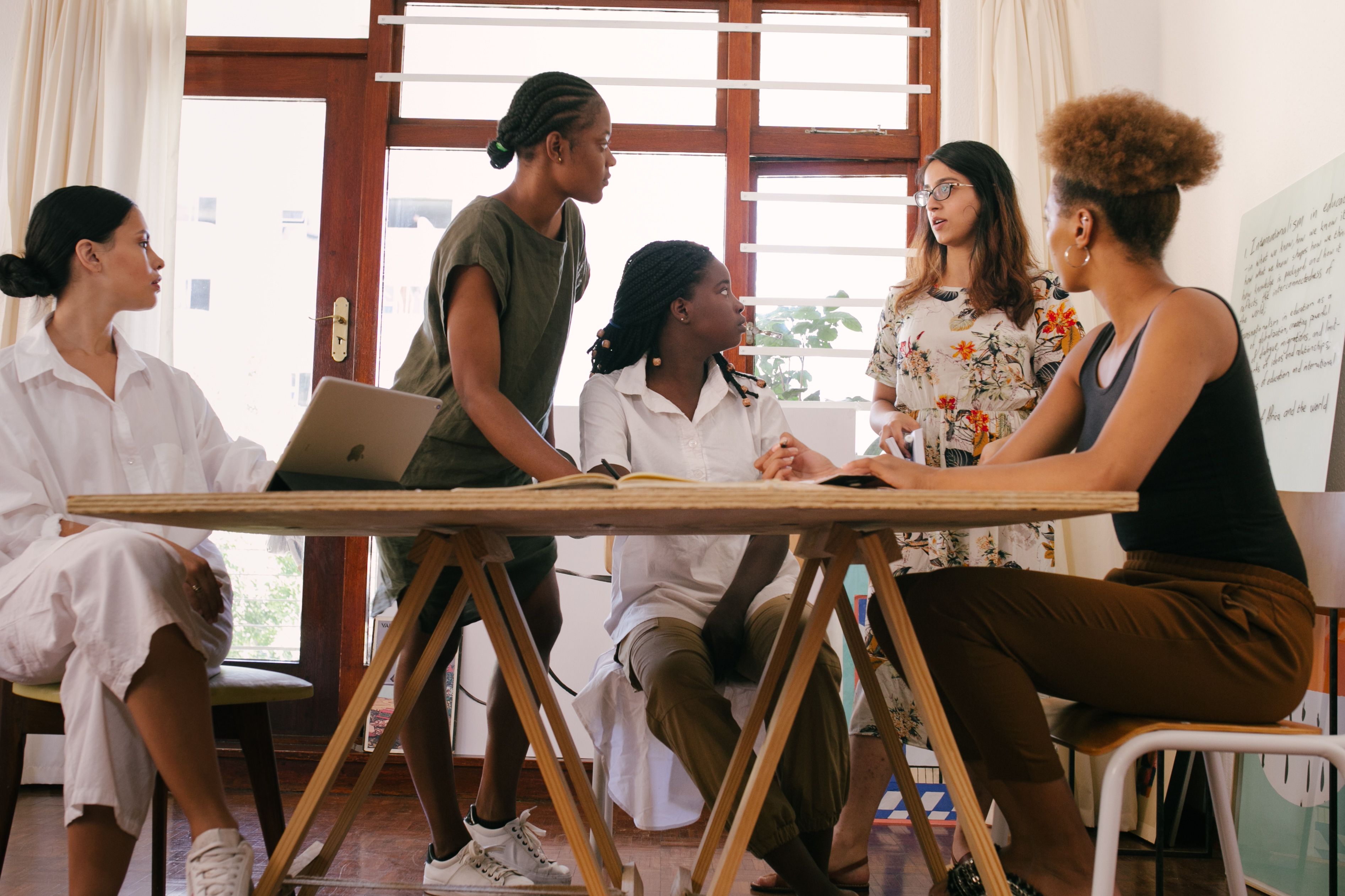 A diverse group of women sharing ideas around a table